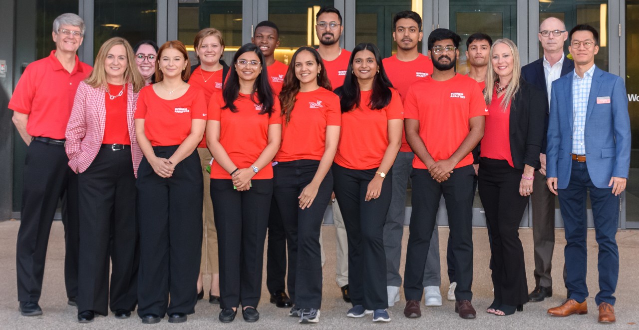 Center for Business Analytics staff and students in professional dress and red shirts.