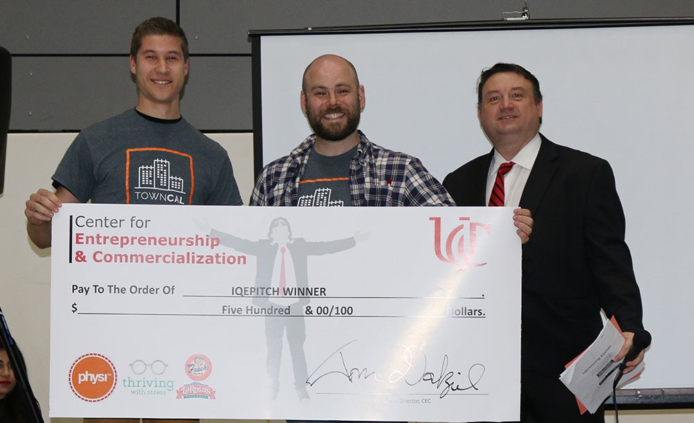 IQ E-Pitch winners pose with a novelty check
