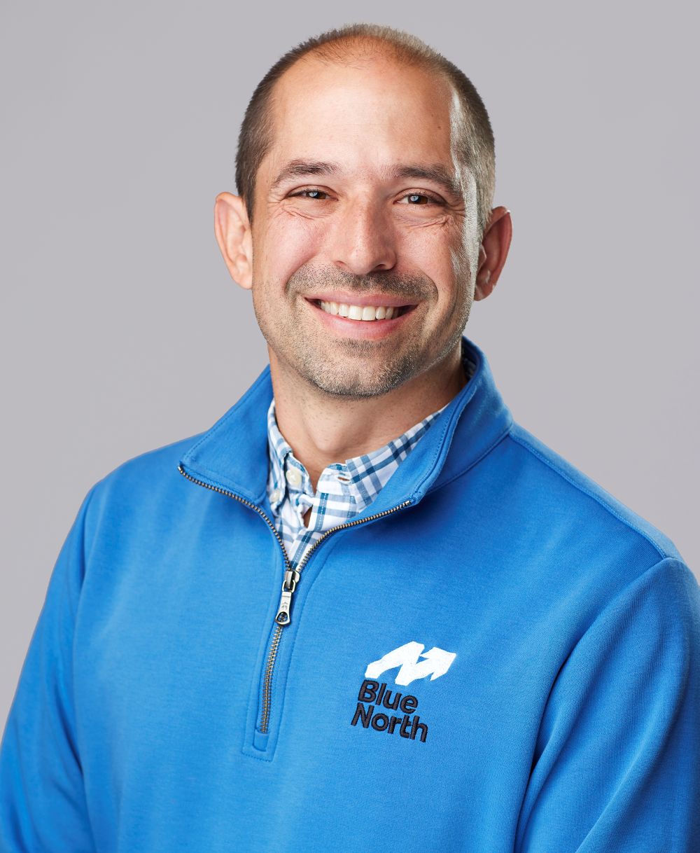 dave knox smiling in a bright blue polo 