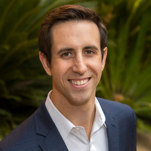professional headshot of ed wearing a blue suit