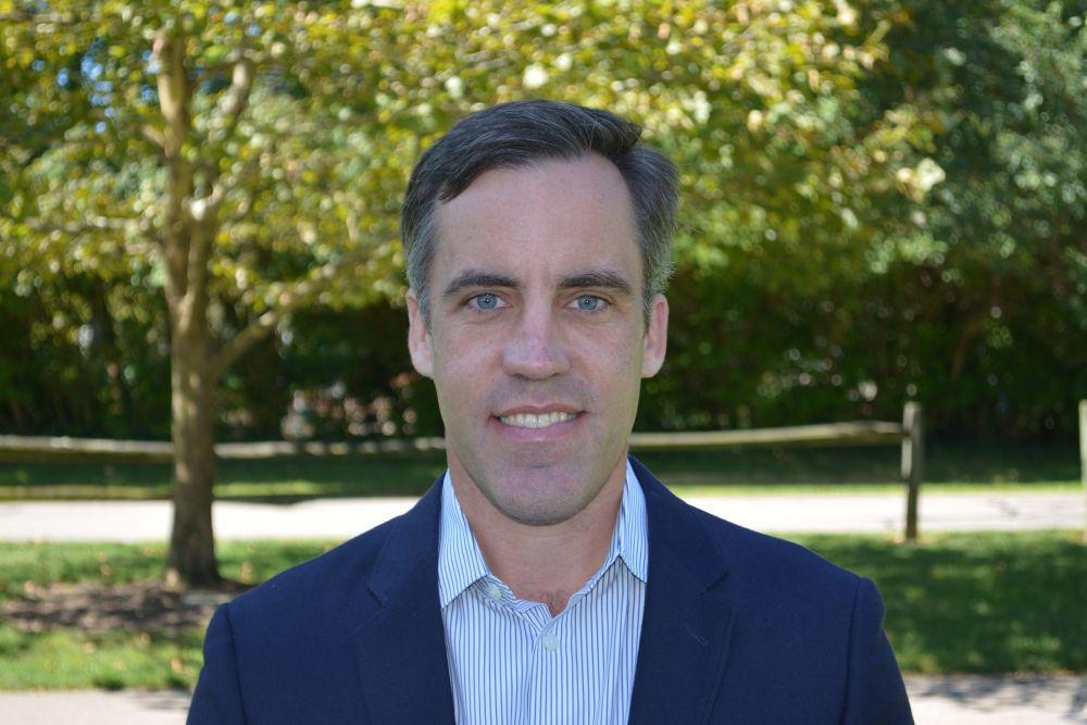 professional headshot of lachlan wearing a blue suit