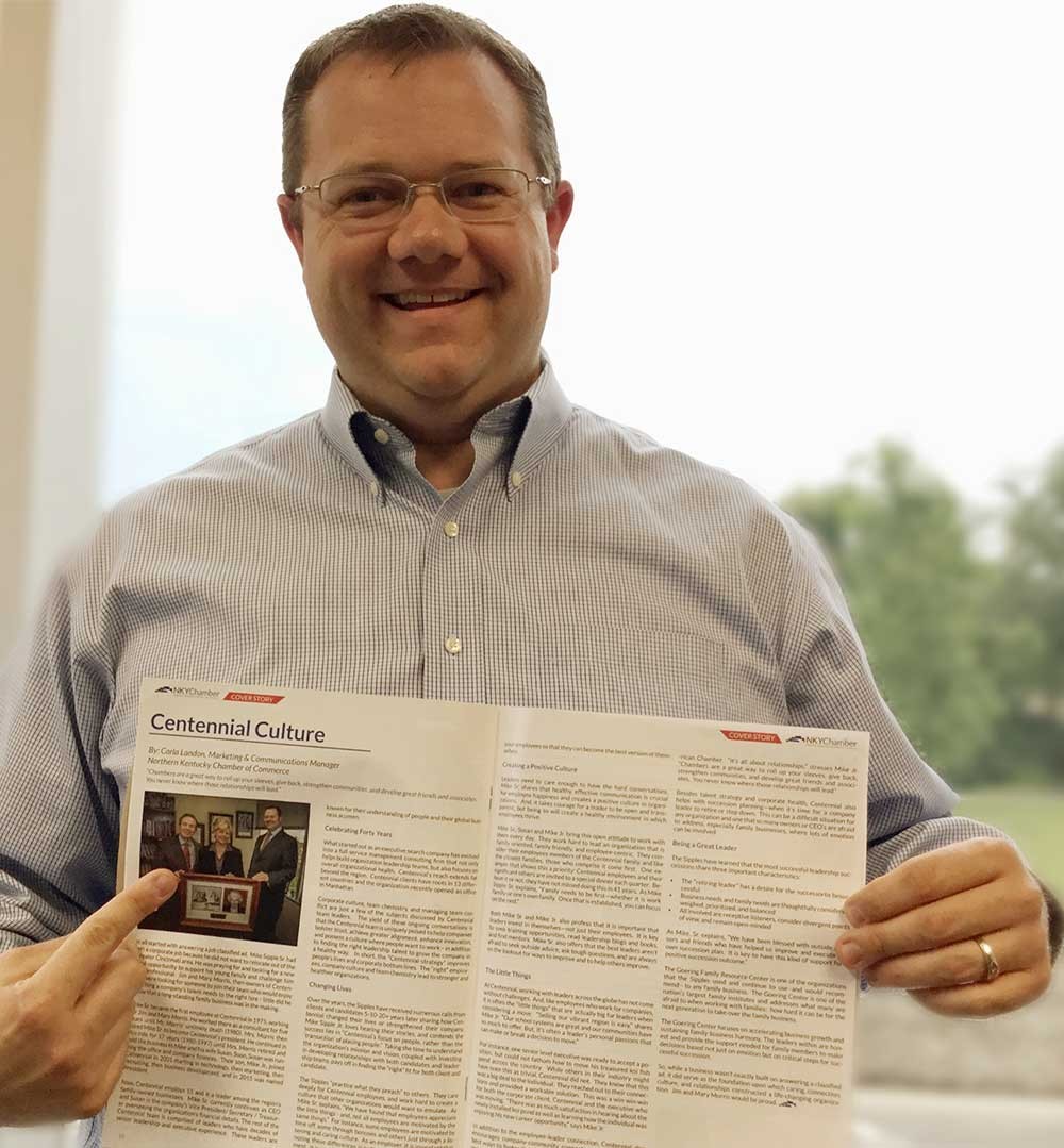 Centennial, Inc.'s Mike Sipple, Jr. holds a magazine article about the company