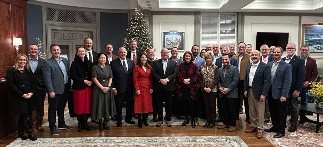 University of Cincinnati Real Estate Center BEARE Board posing for a picture in front of a Christmas tree at the roundtable event
