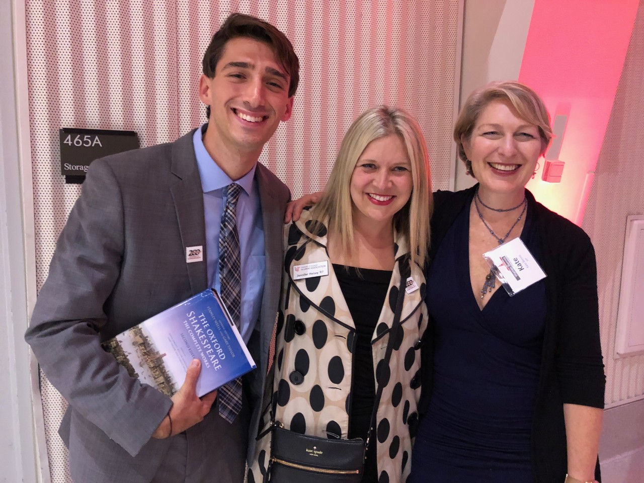 A man and two women pose for a photo.