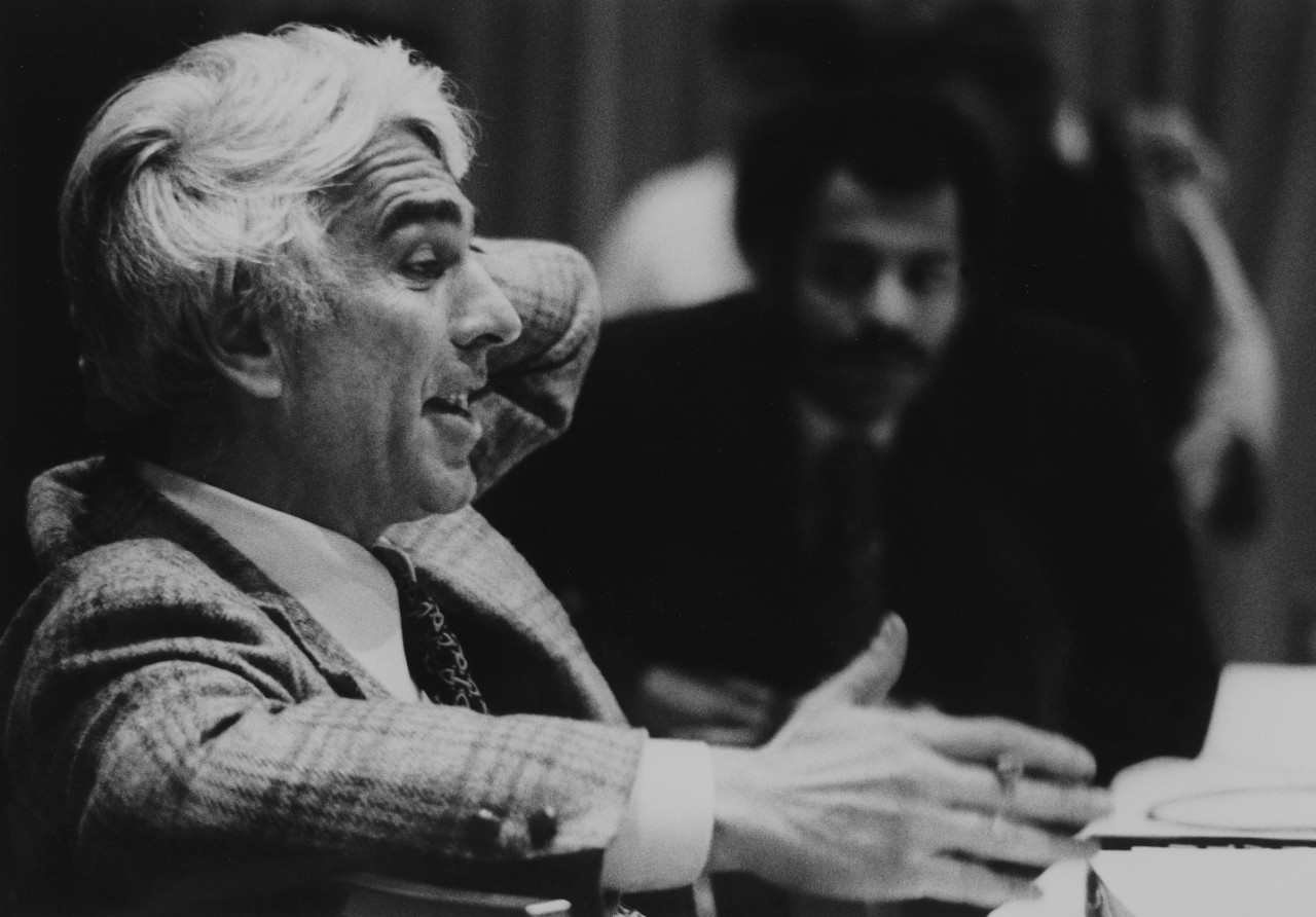 A man speaks to a group of people.