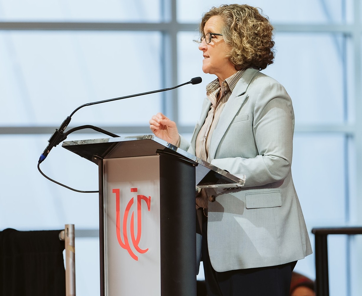 A woman addresses a crowd.