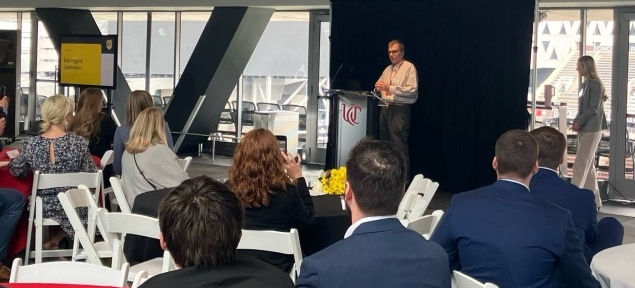 A man stands at a podium in front of a crowd.