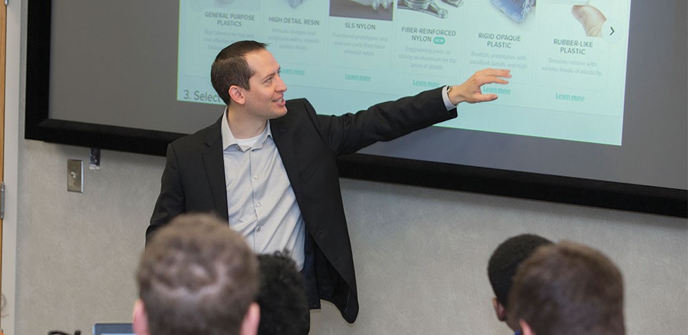 Professor Elliott Manzon presenting to students