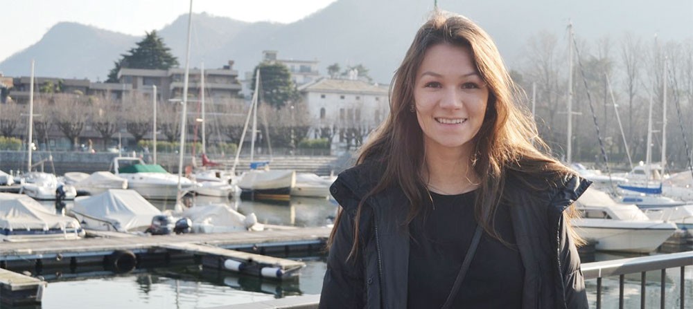 Rachel Kimura standing on a bridge overlooking boats in a harbor
