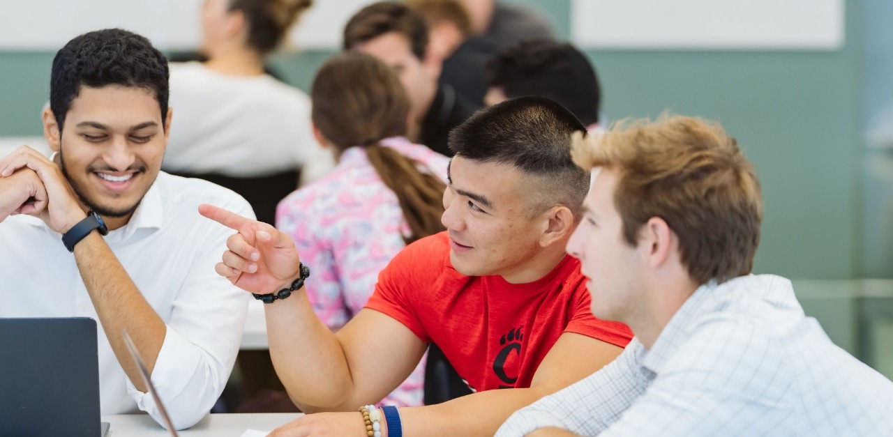 MBA landing page 3 men at table