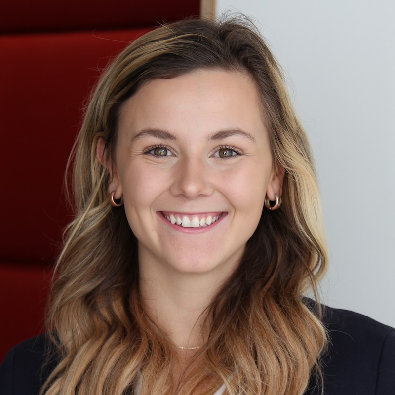 Headshot of Sarah Schaefer inside Lindner Hall wearing hoop earrings and a black top