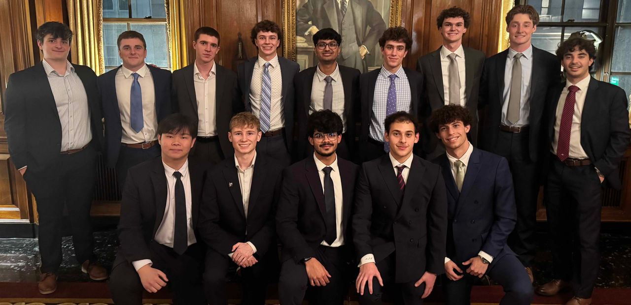 A group of students in professional dress pose for a picture.
